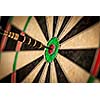 Success hitting target aim goal achievement concept background - dart in bull's eye close up