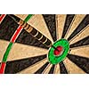 Success hitting target aim goal achievement concept background - dart in bull's eye close up