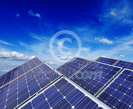 Solar power generation technology, green alternative energy and environment protection ecology business concept background - solar battery panels under blue sky