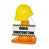 Under construction concept background - yellow hard hat on orange highway traffic construction cone with white stripes with plate isolated on white
