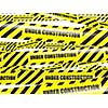 Under construction concept background - yellow warning caution ribbon tape on white background with selective focus shallow depth of field