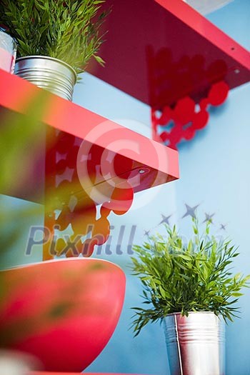 Close/up or red shelves on a light blue wall Close/up or red shelves on a light blue wall