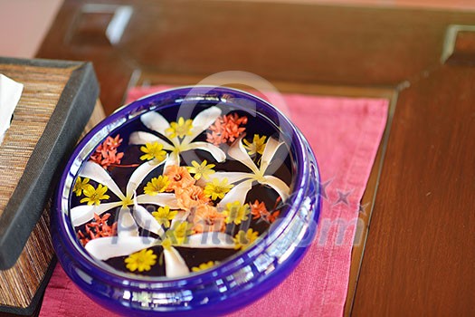 water cup with beautiful flowers, a variety of background colors in spa health and beauty center water cup with beautiful flowers, a variety of background colors in spa health and beauty center