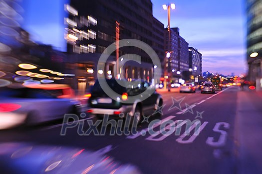 busy traffic scene of street in night  with car traffic and vivid colored city scene