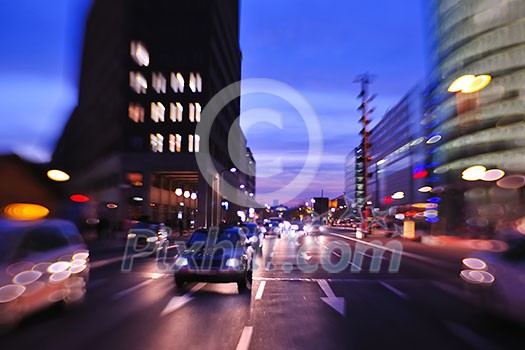 busy traffic scene of street in night  with car traffic and vivid colored city scene
