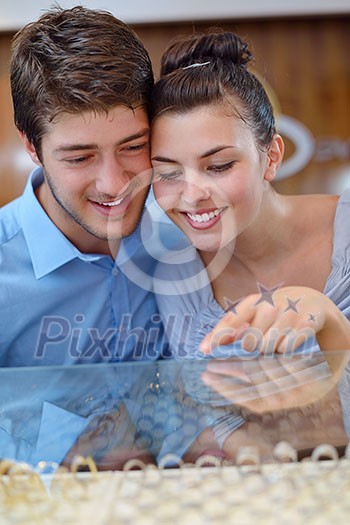 happy young romantic couple in love buy jewelry ring in luxury store happy young romantic couple in love buy jewelry ring in luxury store
