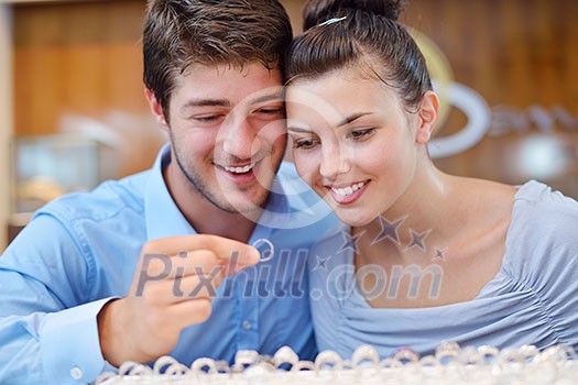 happy young romantic couple in love buy jewelry ring in luxury store happy young romantic couple in love buy jewelry ring in luxury store