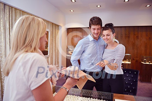 happy young romantic couple in love buy jewelry ring in luxury store