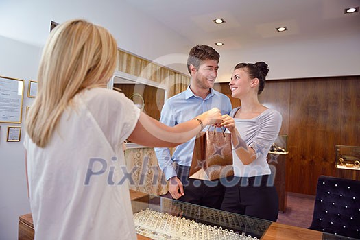 happy young romantic couple in love buy jewelry ring in luxury store happy young romantic couple in love buy jewelry ring in luxury store