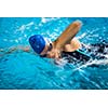 Female swimmer in an indoor swimming pool - doing crawl (shallow DOF)