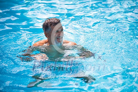 Senior man in his home swimming pool, enjoying the deserved retirement Senior man in his home swimming pool, enjoying the deserved retirement