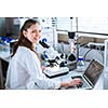 Portrait of a female chemistry student carrying out research in a chemistry lab (color toned image; shallow DOF)