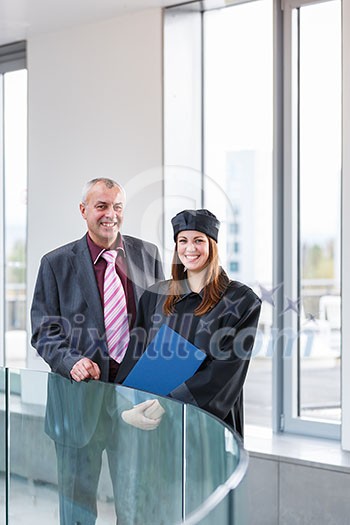 Pretty female university graduate with her happy and proud father, moments after getting the diploma Pretty female university graduate with her happy and proud father, moments after getting the diploma