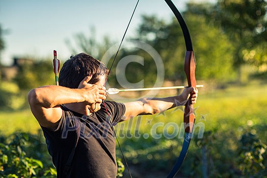 Young archer training with the bow Young archer training with the bow