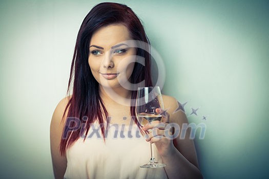Pretty, young woman having a glass of wine (color toned image)