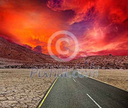 Road in desert on sunset