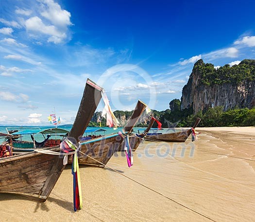 Long tail boats on tropical beach (Railay beach) in Thailand Long tail boats on tropical beach (Railay beach) in Thailand