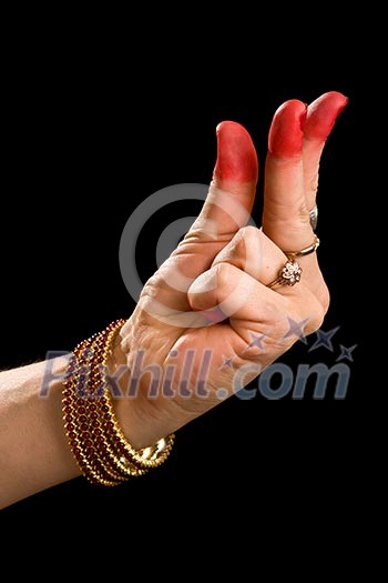 Woman hand showing Kangula hasta (hand gesture, also called mudra) (meaning 'Tail') of indian classic dance Bharata Natyam. Also used in other indian classical dances Kuchipudi and Odissi. Woman hand showing Kangula hasta (hand gesture, also called mudra) (meaning 'Tail') of indian classic dance Bharata Natyam. Also used in other indian classical dances Kuchipudi and Odissi.