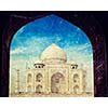 Vintage retro hipster style travel image of Taj Mahal through arch, Indian Symbol - India travel background. Agra, Uttar Pradesh, India with grunge texture overlaid