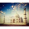 Vintage retro hipster style travel image of 
Taj Mahal on sunrise. Indian Symbol - India travel background with grunge texture overlaid. Agra, India