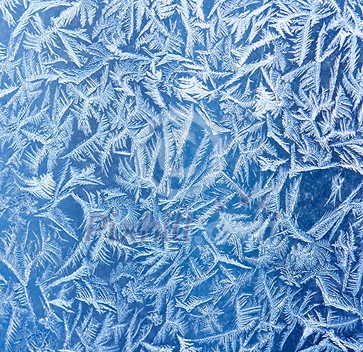 Frost patterns on window glass in winter