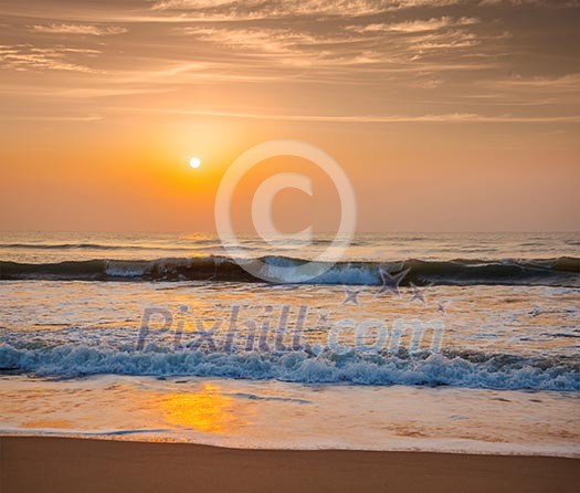 Sunrise on beach with dramatic sky