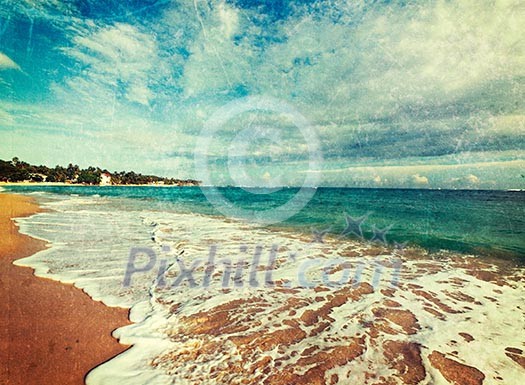 Vintage retro hipster style travel image of tropical paradise idyllic beach with grunge texture overlaid. Sri Lanka