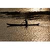 Man in canoe on sunrise. Kerala backwaters, India