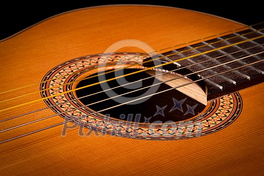 Classical guitar close up on dark background