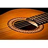 Classical guitar close up on dark background