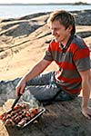 A man enjoying a barbecue by the sea