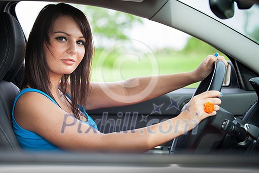 Pretty young woman driving her new car Pretty young woman driving her new car