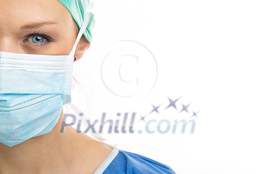Close up of a pretty, blue-eyed, female surgeon. Half face composition. Looking confident and professional