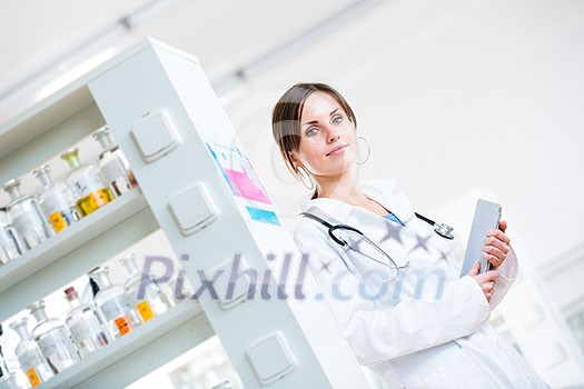 Pretty, female doctor in a hospital lab (image with copy space; color toned)