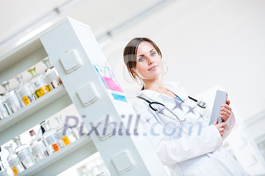 Pretty, female doctor in a hospital lab (image with copy space; color toned) Pretty, female doctor in a hospital lab (image with copy space; color toned)