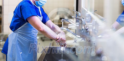 Surgeon in hospital washing thorouughly his hands before performing a surgery (color toned image; shallow DOF) Surgeon in hospital washing thorouughly his hands before performing a surgery (color toned image; shallow DOF)