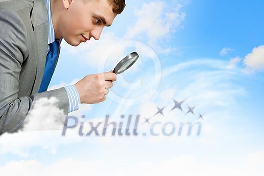 Image of businessman looking in magnifying glass Image of businessman looking in magnifying glass
