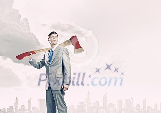 Young businessman holding big axe on shoulder