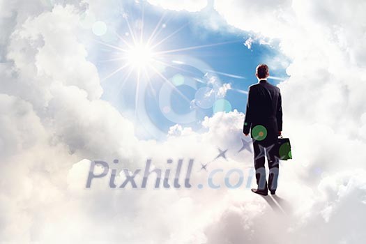 Back view of businessman standing on cloud high in sky Back view of businessman standing on cloud high in sky