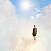 Back view of businesswoman standing on cloud high in sky