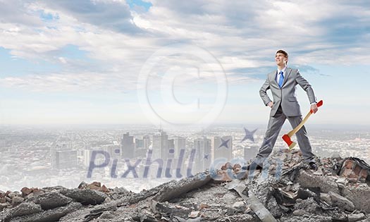 Young determined businessman in suit holding big axe Young determined businessman in suit holding big axe