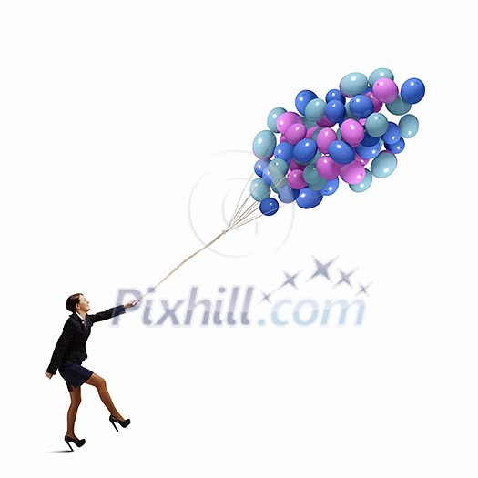 Young joyful businesswoman walking with bunch of colorful balloons Young joyful businesswoman walking with bunch of colorful balloons
