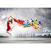 Young woman dancer in red dress jumping high