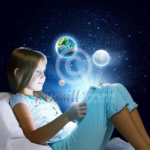 Girl sitting in bed and using tablet pc. Elements of this image are furnished by NASA