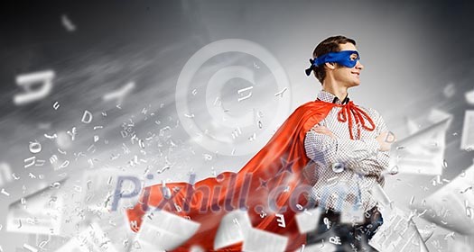 Young confident superman in mask and cape