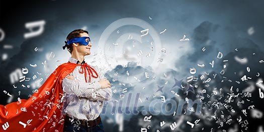 Young confident superman in mask and cape Young confident superman in mask and cape