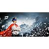 Young confident superman in mask and cape
