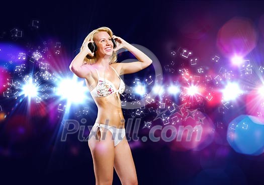 Attractive girl in headphones having fun at disco party Attractive girl in headphones having fun at disco party