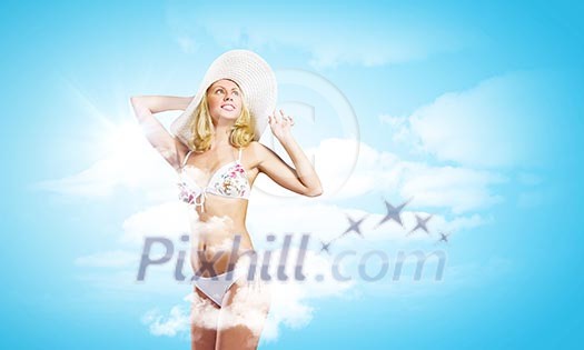 Pretty girl in swimming suit and hat against color background
