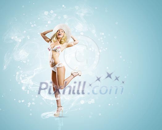 Pretty girl in swimming suit and hat against color background